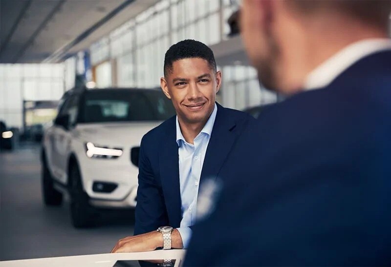 A man sitting with a Volvo representative